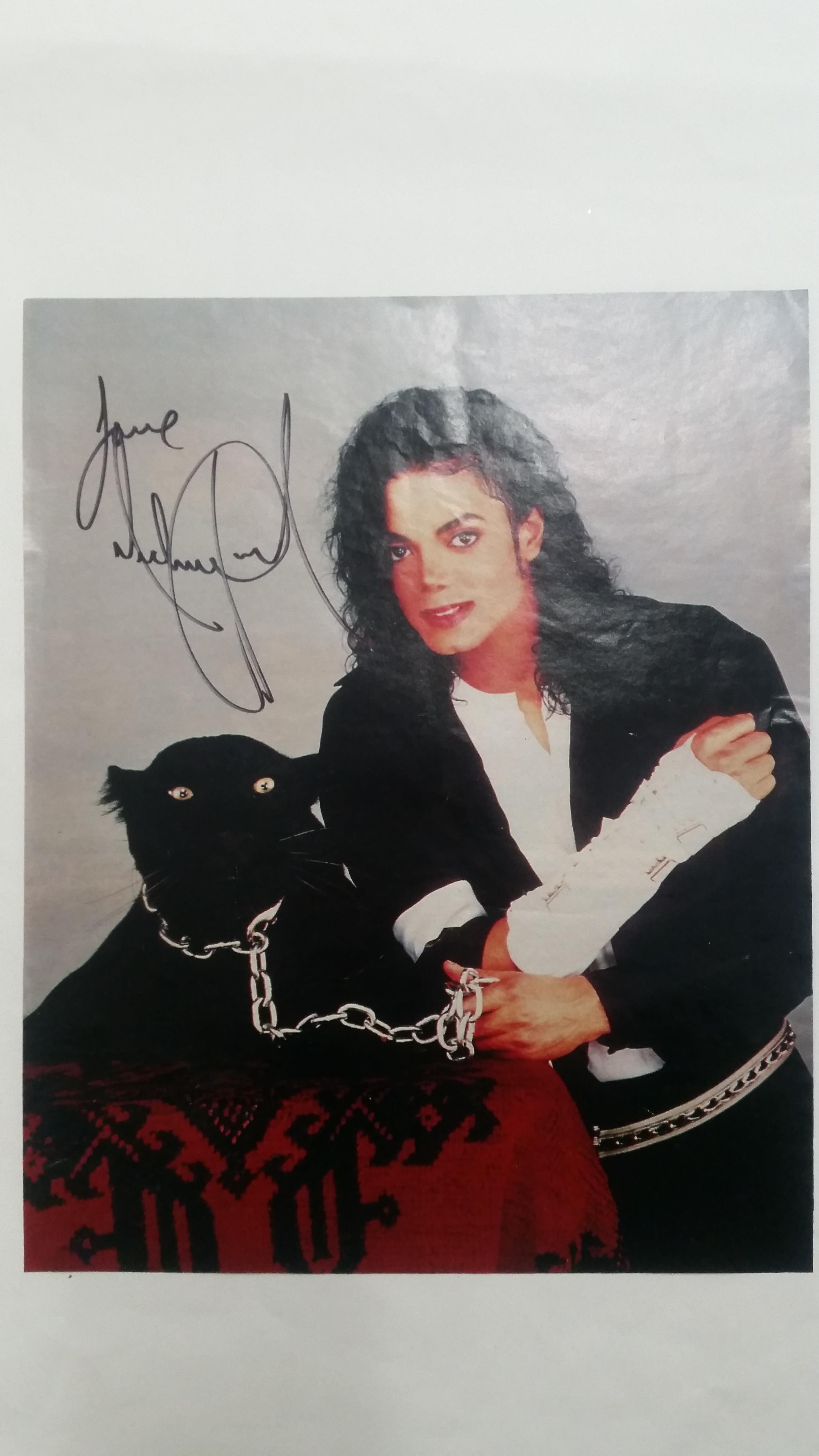 POP MUSIC, signed colour magazine page by Michael Jackson, showing him half-length with panther, 9 x