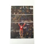 GYMNASTICS, signed colour magazine photo by Olga Corbett, full length performing on the uneven bars,