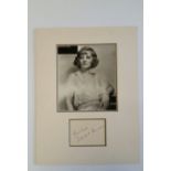CINEMA, signed album page by Tallulah Bankhead, overmounted beneath photo, half-length seated, 12