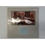 TELEVISION, signed and inscribed by Warren Mitchell, overmounted beneath colour photo, seated in