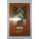 POP MUSIC, signed piece by Cass Elliott, overmounted beneath photo, full-length performing, 11 x
