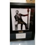 CINEMA, James Bond, signed white card by George Lazenby, overmounted beneath photo, full-length