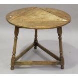 A 20th century provincial style oak drop-flap circular cricket table, on turned legs, height 59cm,