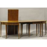 A George III mahogany drop-flap D-end dining table with boxwood stringing, raised on square tapering