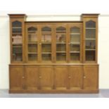 A late Victorian oak six-section library bookcase cabinet, the graduated top with a moulded pediment