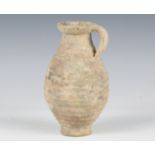 A Roman greyware vessel of ribbed ovoid form, the side with single loop handle, height 21cm.Buyer’