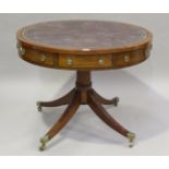 A George III mahogany drum-top library table, the top inset with gilt-tooled brown leather above a