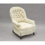 A Victorian tub back salon armchair with buttoned taupe upholstery, on turned legs and castors,