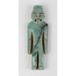 A pre-Columbian Olmec style carved apple green jade figure of a standing male, probably 900-450