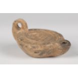 A Roman terracotta oil lamp, the central well decorated with a palmette, length 8.5cm.Buyer’s