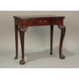 A George II mahogany fold-over card table, the hinged top with projecting corners above a single