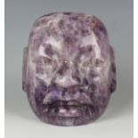 A pre-Columbian Olmec style finely carved amethyst quartz mask, probably 800-400 BC, with pierced