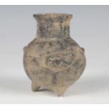 A Yortan culture earthenware tripodal vessel, the rounded body with lobed points and incised