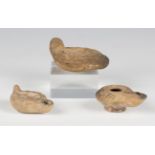 A group of three Roman terracotta oil lamps, one moulded with a horse, length 8cm.Buyer’s Premium