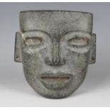 A pre-Columbian Teotihuacan style carved green hardstone mask, probably 250-700AD, with pierced ears