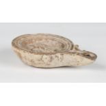 A Roman terracotta oil lamp, the central well decorated with an eagle within a multiple ribbed edge,