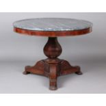 A mid-19th century French mahogany circular centre table with grey marble top, raised on a