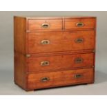 A late 19th century teak and brass bound campaign chest by Army & Navy, fitted with two short and