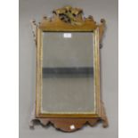A 20th century George III style walnut and parcel gilt fretwork wall mirror, 70cm x 40cm.Buyer’s