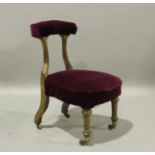 An early Victorian walnut framed cockfighting chair, possibly Irish, upholstered in claret velour,