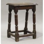A 17th century oak joint stool, raised on turned and block legs, height 54cm, width 41cm, depth 25.