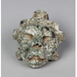 A pre-Columbian Olmec style carved apple green and white mottled hardstone transformation shaman's