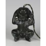 A pre-Columbian Mayan style carved black hardstone figure of a squatting male, length 6cm.