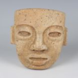 A pre-Columbian Teotihuacan style carved buff hardstone mask, probably 250-700 AD, with pierced