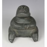 A pre-Columbian Olmec style carved green hardstone figure, probably 900-450 BC, modelled as a seated