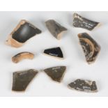 A small collection of Roman and Greek pottery fragments, including four pieces of impressed