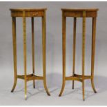 A pair of 20th century Neoclassical style satin birch and foliate painted oval tables, height