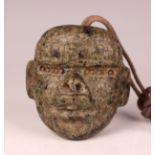 A pre-Columbian Olmec style carved mottled green hardstone transformation mask, probably 900-450 BC,
