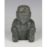 A pre-Columbian Olmec style carved green hardstone figure of a seated elderly man, probably 900-