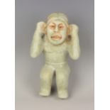 A pre-Columbian Olmec style carved pale green hardstone figure of a water carrier, probably 900-
