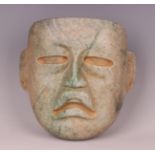 A large pre-Columbian Olmec style finely carved green hardstone mask, probably 900-450 BC, with