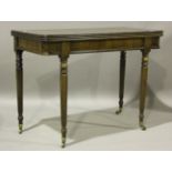 A William IV mahogany fold-over tea table with a reeded edge top and reeded legs, terminating in