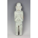A substantial pre-Columbian Olmec style carved pale green hardstone standing male figure, probably