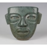 A pre-Columbian Teotihuacan style carved green hardstone mask, probably 250-700 AD, with pierced