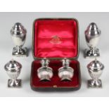 A pair of Victorian silver pepper casters of urn form, Birmingham 1885 by George Unite, height 7.