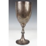 A George V silver trophy cup, the 'U' shaped bowl with engraved presentation inscription, on a