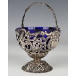 A late Victorian silver bonbon basket with swing handle, the sides pierced and embossed with cherubs