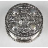 A late 19th/early 20th century German .800 silver circular box, the hinged lid inset with four