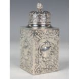 A late Victorian silver rectangular tea caddy with reeded domed cover and flower bud finial, each