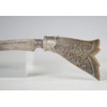 An early 20th century Malaysian kris dagger with swept curved blade, blade length 22cm, and silver-