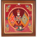 An early 20th century framed military woolwork panel depicting the crest and various victories of