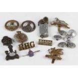 Seven cap badges, including King's African Rifles, Royal Engineers and West Yorkshire, six LMS