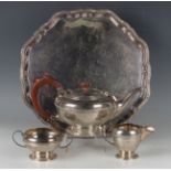 An Elizabeth II silver three-piece tea set of squat circular form, cast with a Celtic band,