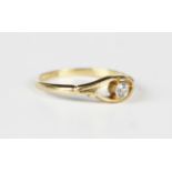 A gold, platinum and diamond single stone ring, mounted with a circular cut diamond in an oval