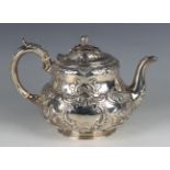 A Victorian silver teapot of circular low-bellied bombé form, the hinged lid with rose bud and