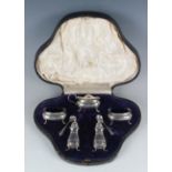 An Edwardian silver five-piece condiment set of oval form, comprising mustard, pair of salts and